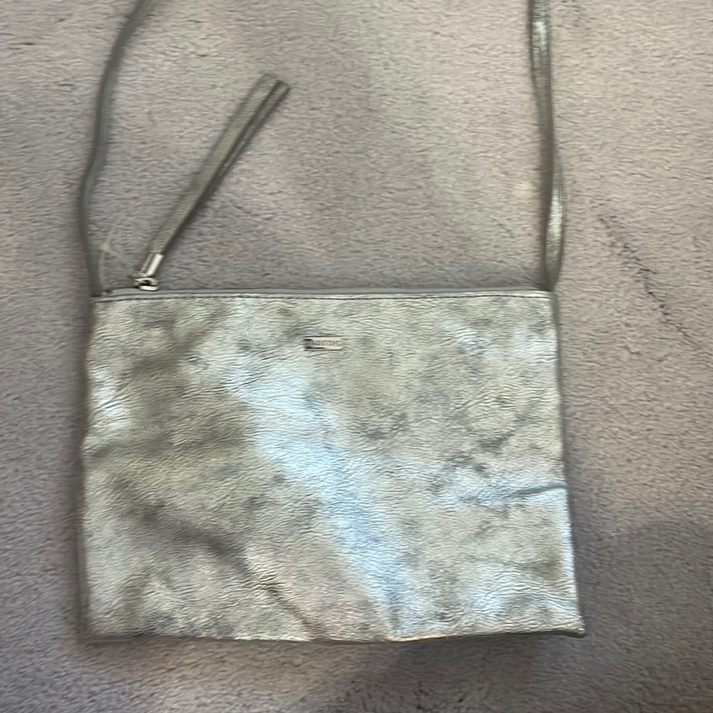 Small silver clutch with adjustable strap. Never been used.